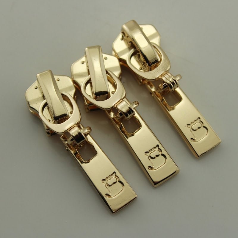 Custom branded zipper pullers with engraved logo